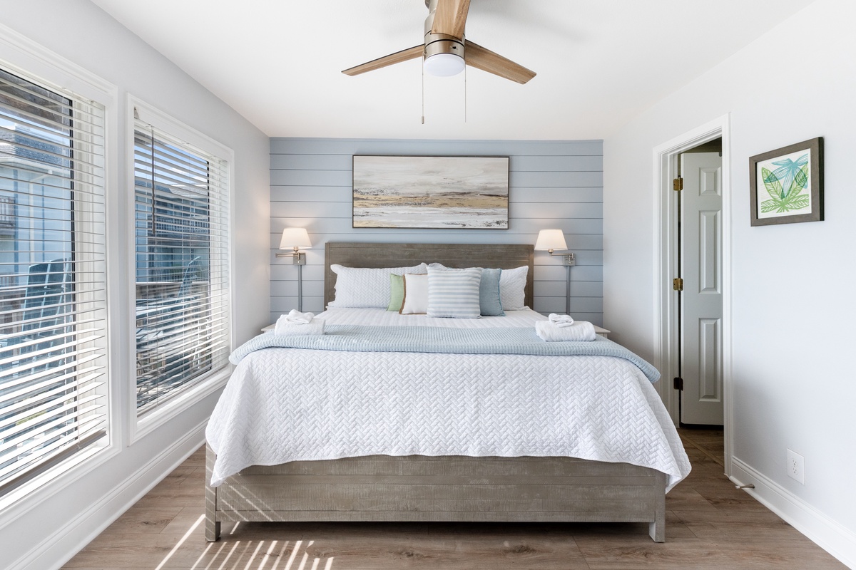 Drift into peaceful dreams in your coastal-inspired bedroom with crisp linens, gentle ceiling fan breezes, and coastal artwork.
