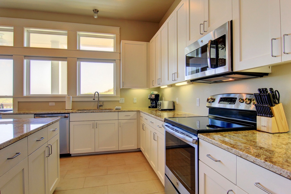 Cook memorable meals in this bright, fully-equipped kitchen with granite counters, modern appliances, and all the tools you need for your getaway.