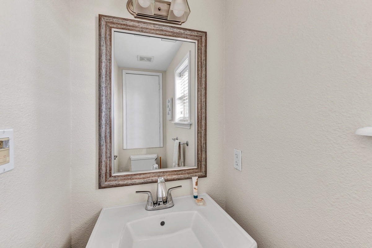 Freshen up in your bright, beautifully appointed bathroom with elegant fixtures and natural light streaming through the window.