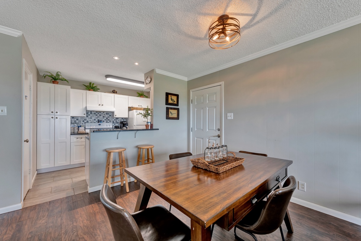 Gather around the warm wood dining table where memories are made over home-cooked meals from your fully equipped kitchen.