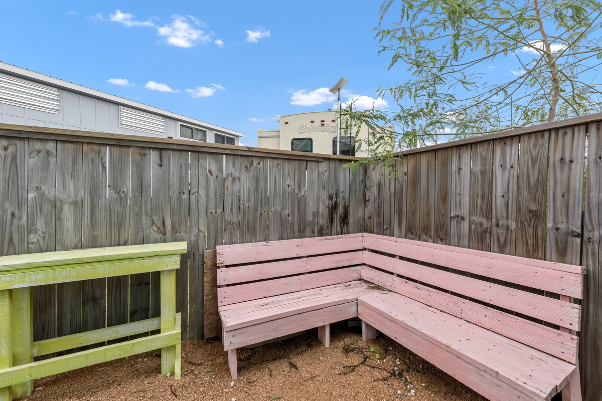 Relax on your private corner bench in this cozy fenced patio space, perfect for quiet mornings with coffee.