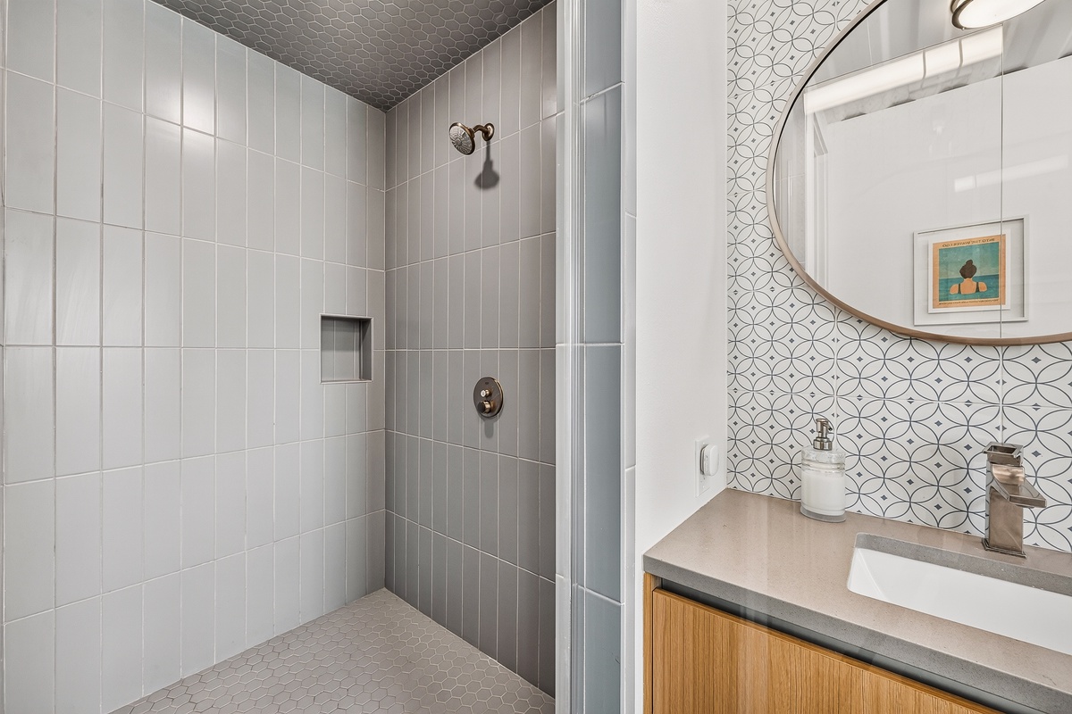 Refresh after a day of exploring in your sleek, primary bathroom—spacious walk-in shower, stylish tile accents, and thoughtful details await your arrival.