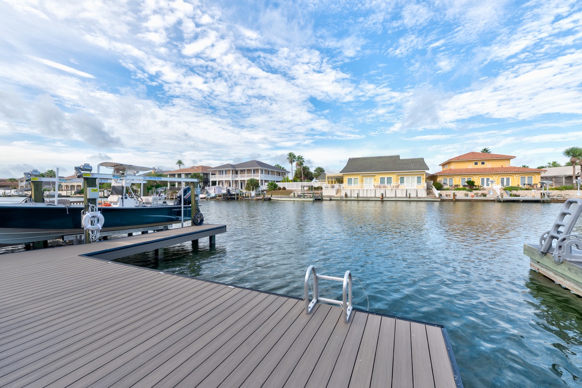 Waterfront neighborhood along a tranquil canal lined with homes and boat docks, offering peaceful access to the surrounding waterways and marina activities.