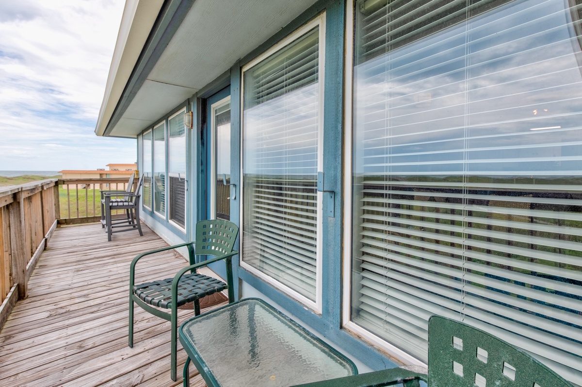 Step onto your private deck where ocean breezes flow through large windows and comfortable seating awaits your morning coffee or sunset contemplation.