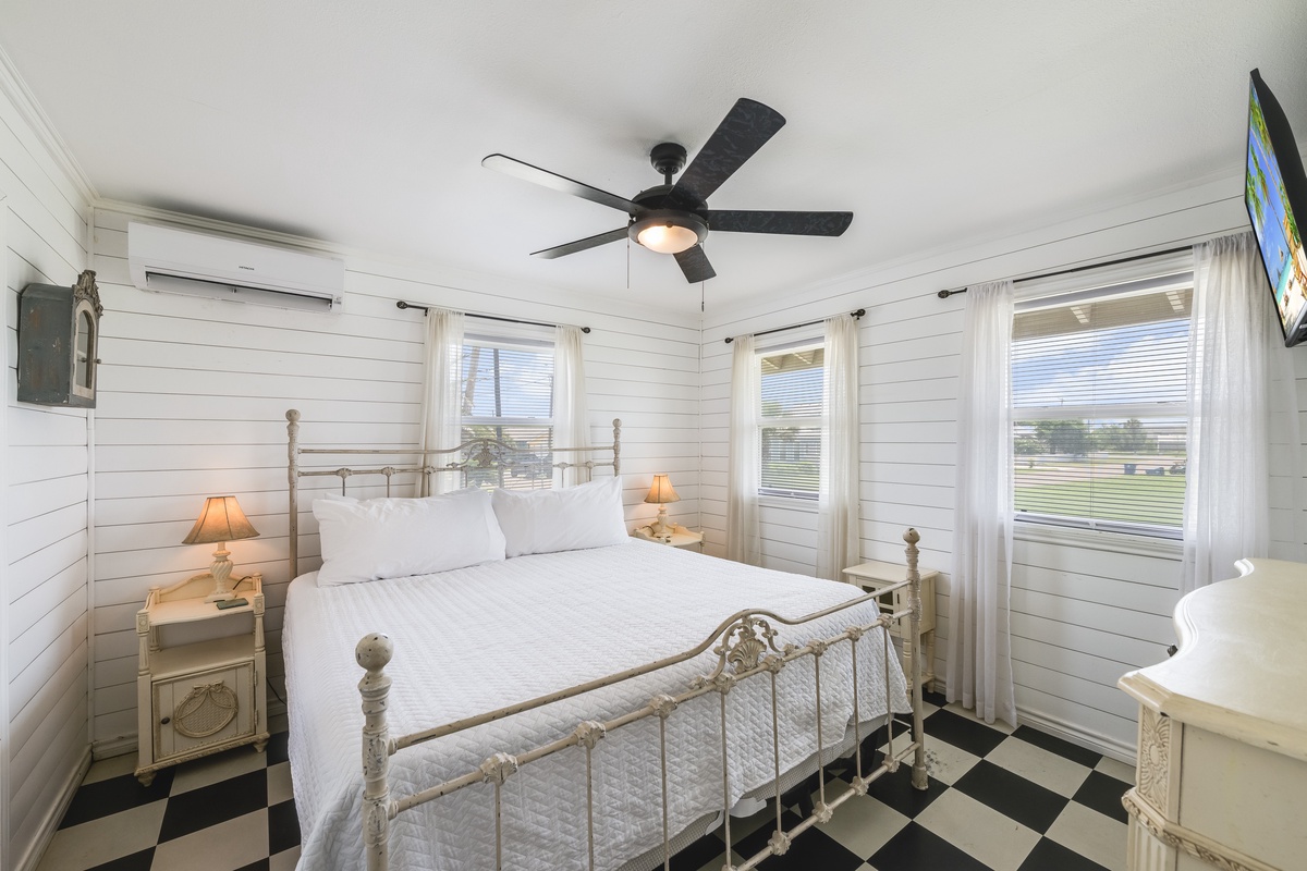 Your peaceful retreat features a cozy bed with crisp linens, charming shiplap walls, and farmhouse-style details that invite you to unwind after a day of adventure.
