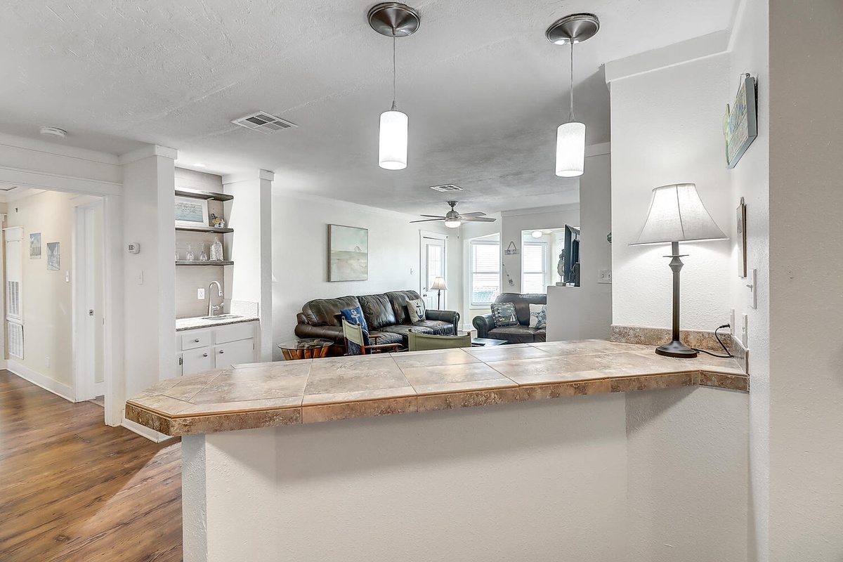 Gather around your spacious granite breakfast bar, perfectly positioned to keep conversations flowing between kitchen and living room.