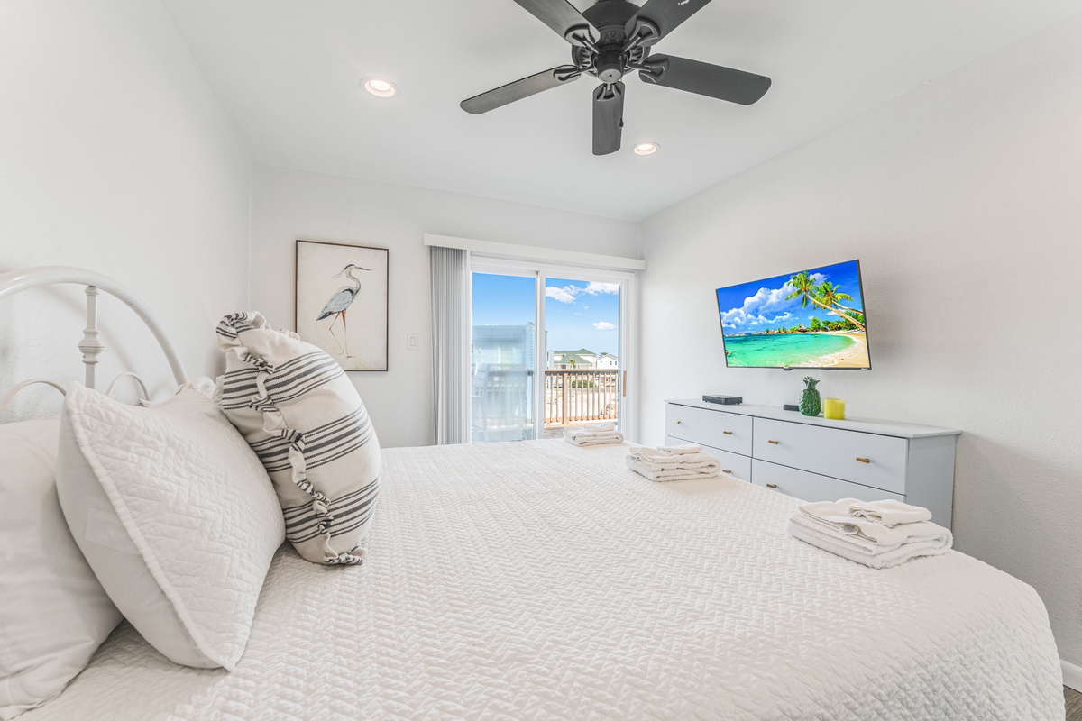 Wake up to coastal breezes in your serene bedroom with balcony access and modern amenities for ultimate relaxation.