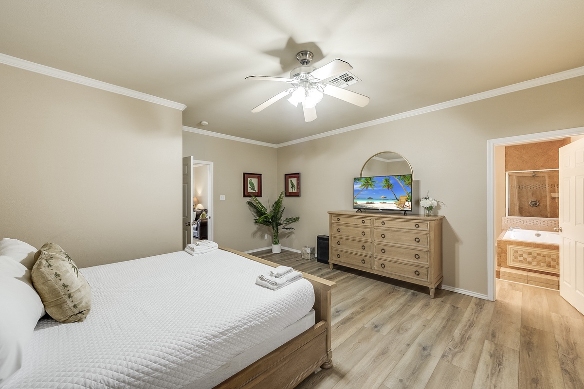 Unwind in your serene bedroom retreat with plush linens, tropical decor, and your own en-suite bathroom sanctuary.