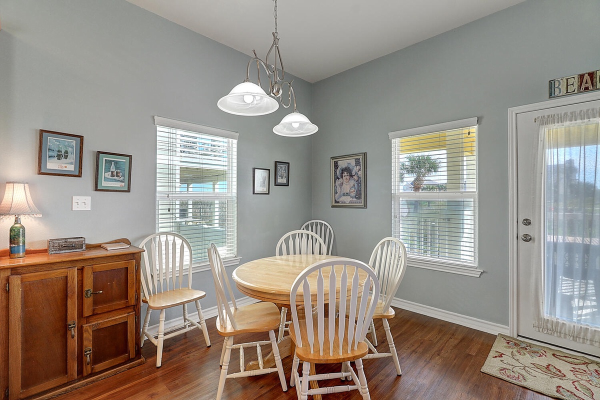Your cozy dining space features a charming round table where you'll enjoy meals together, surrounded by coastal charm and warm natural light.