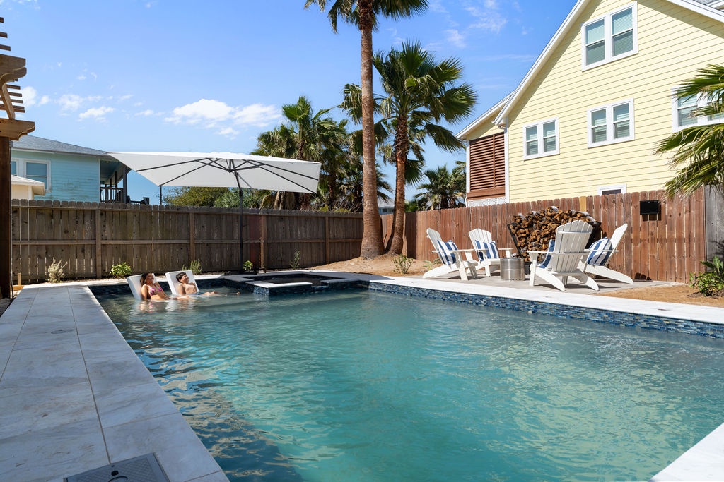 Dive into your private paradise with a sparkling pool surrounded by tropical palms and comfy loungers for ultimate relaxation.