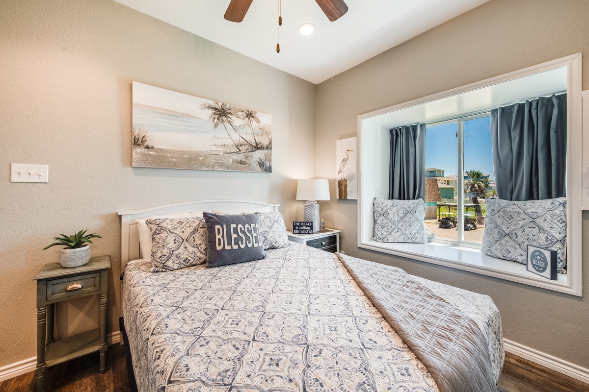 Sink into this blessed bedroom where coastal art and soft linens create your perfect retreat.