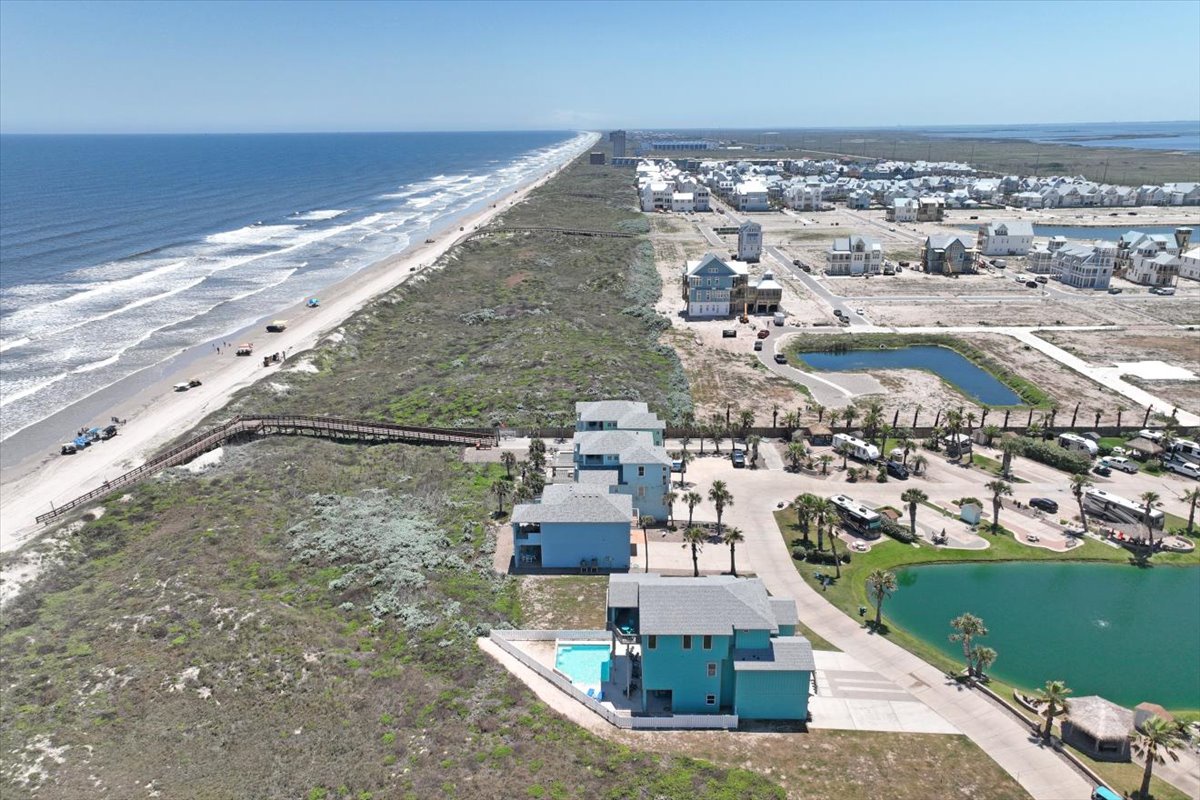 Beachfront community featuring coastal homes, recreational lakes, and pristine sandy shoreline stretching along the Gulf waters.