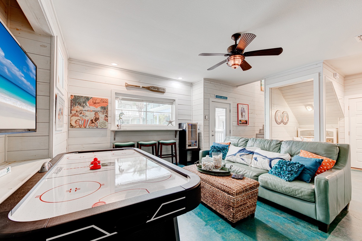 Unwind in your game room with air hockey and coastal comfort—perfect for fun-filled evenings with family and friends.