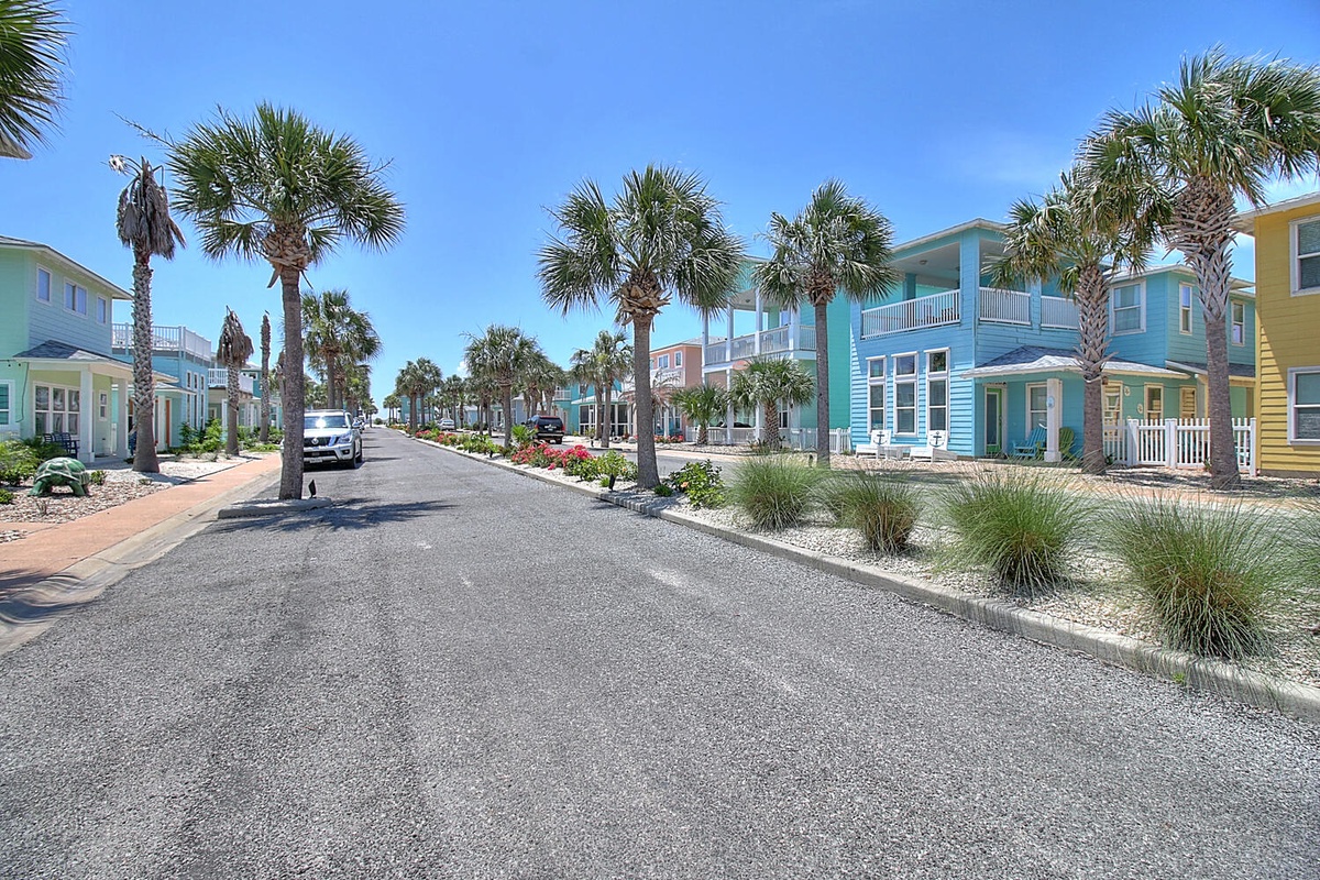 Colorful beachside neighborhood with palm-lined streets and tropical landscaping near the property.