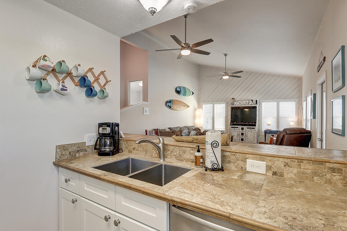 Your fully equipped kitchen flows seamlessly into the bright living area, perfect for cooking and connecting with family.