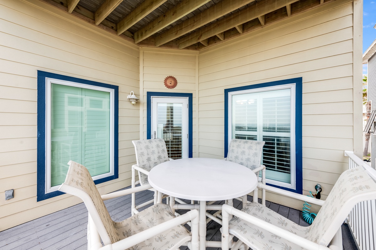Unwind on your private covered balcony with comfortable seating and coastal charm, perfect for morning coffee or sunset conversations.
