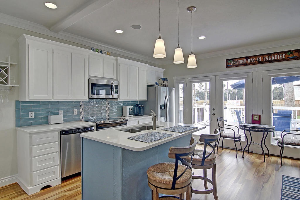 Your fully equipped kitchen features modern appliances, beautiful backsplash, and breakfast bar seating where you can enjoy morning coffee.