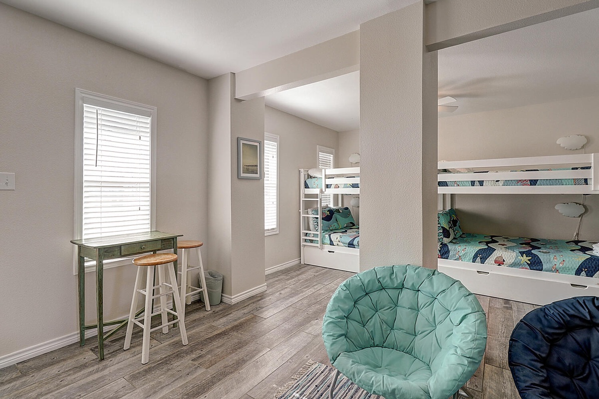 Your kids will love this fun bunk room with comfy seating and a study desk by sunny windows.
