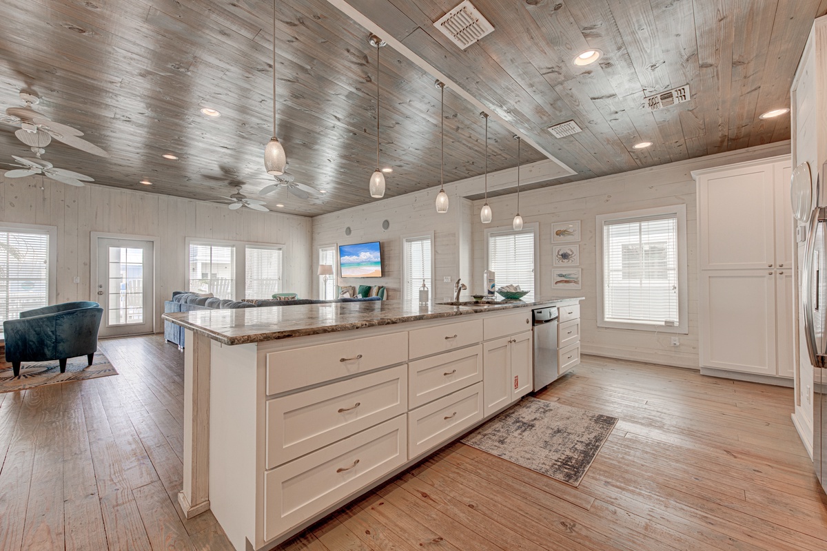 Your spacious kitchen features granite countertops, modern appliances, and stunning wood-planked ceilings that create the perfect space for vacation cooking.