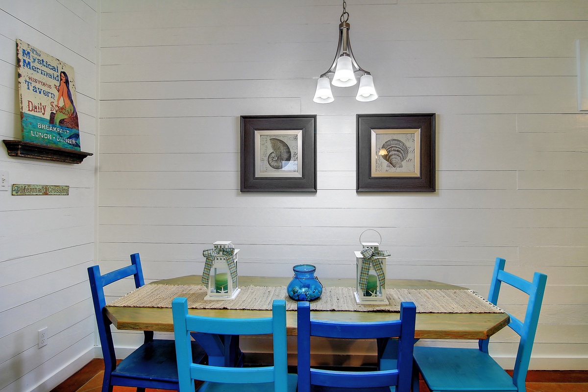 Your charming dining space awaits with coastal-inspired blue chairs and rustic touches that create the perfect spot for memorable meals together.