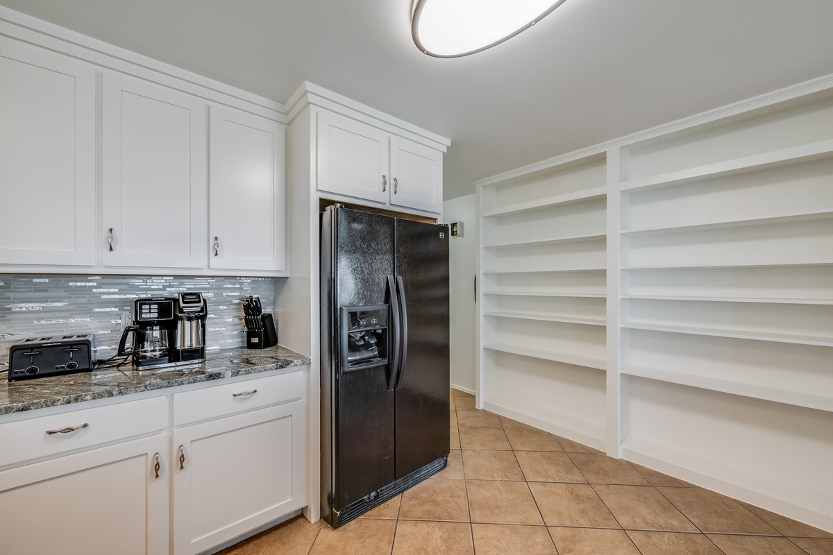Your spacious pantry features built-in shelving and granite counters with coffee station - perfect for organizing all your vacation groceries.