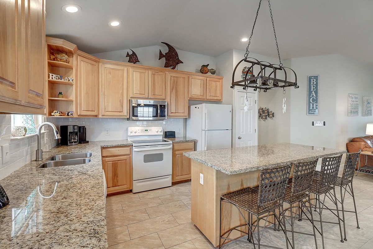 Your fully equipped kitchen features granite countertops, stainless appliances, and a breakfast bar where you can gather with loved ones.