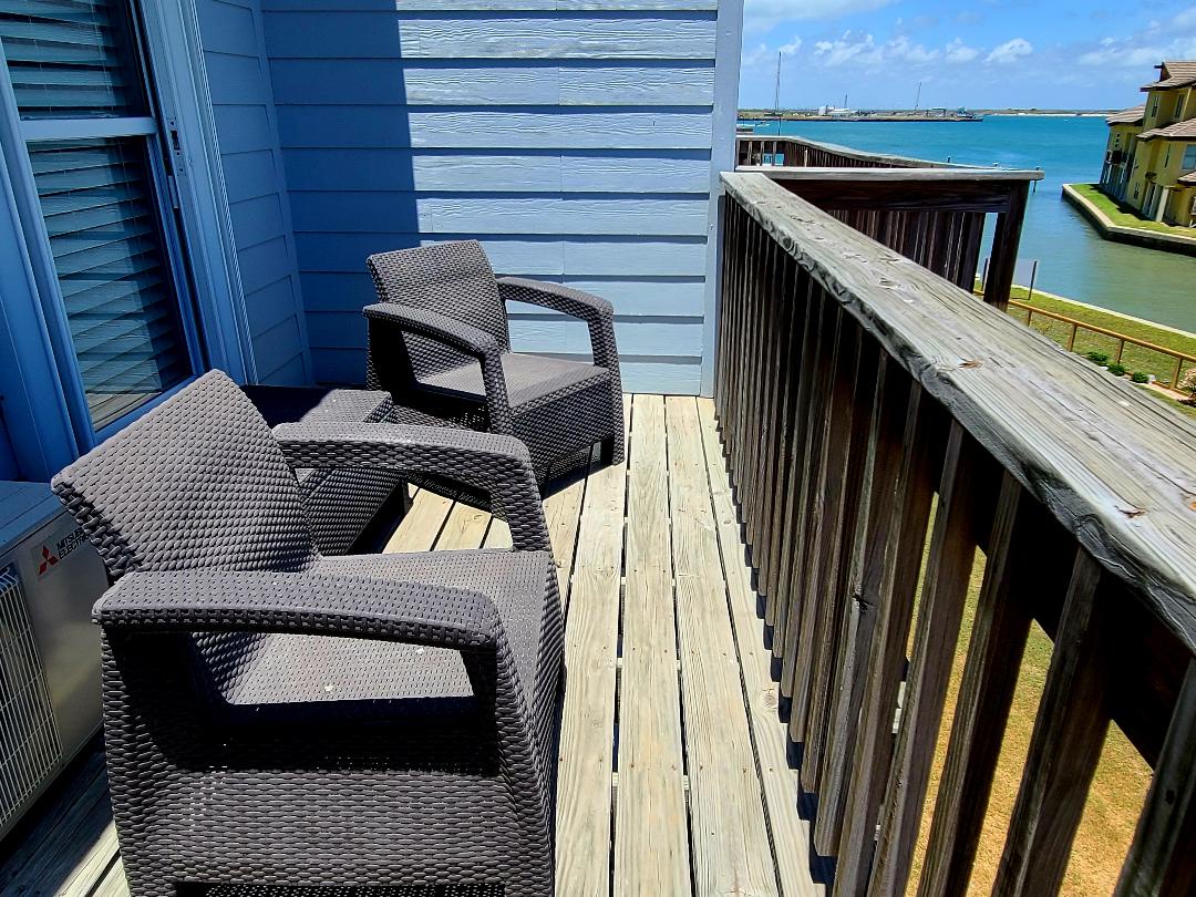 Relax on your private deck with comfortable seating while taking in stunning turquoise waters and coastal views.