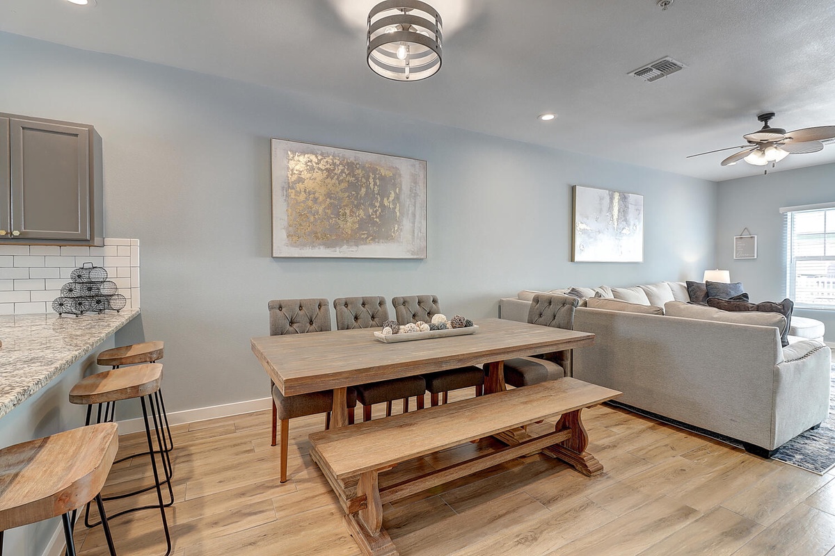 Gather around the rustic wooden dining table where your group can share meals and create memories in this stylish open-plan space.