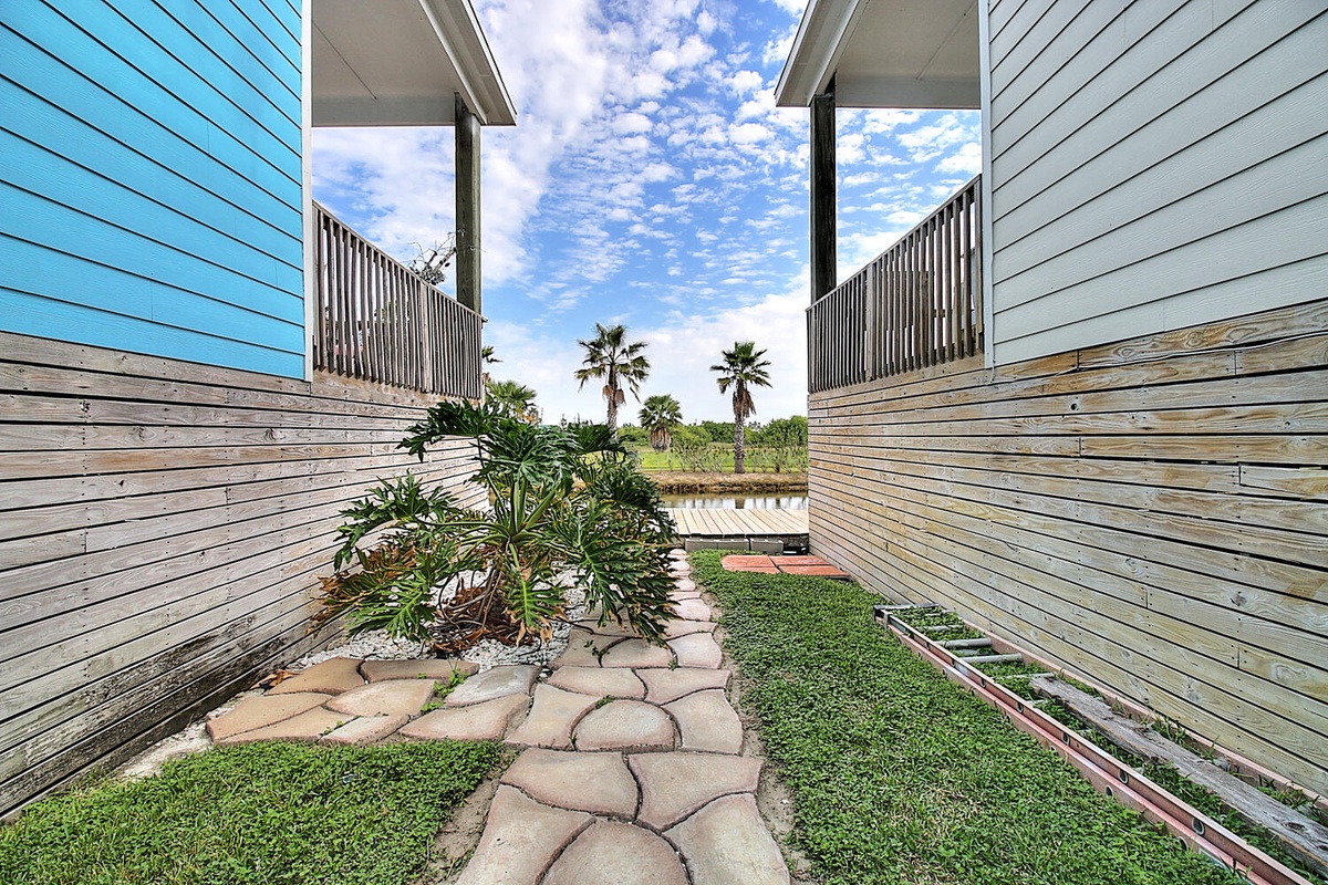Step into your private courtyard oasis, where tropical palms frame the sky and stone pathways invite peaceful moments outdoors.