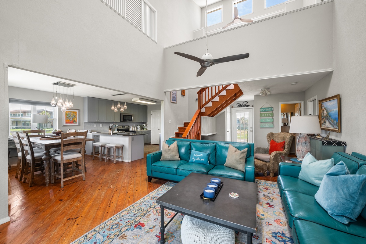 Unwind in your open-concept living area with soaring ceilings and rich wood floors. Sink into plush seating, prepare meals in the modern kitchen, and enjoy the light-filled space perfect for gathering with loved ones.