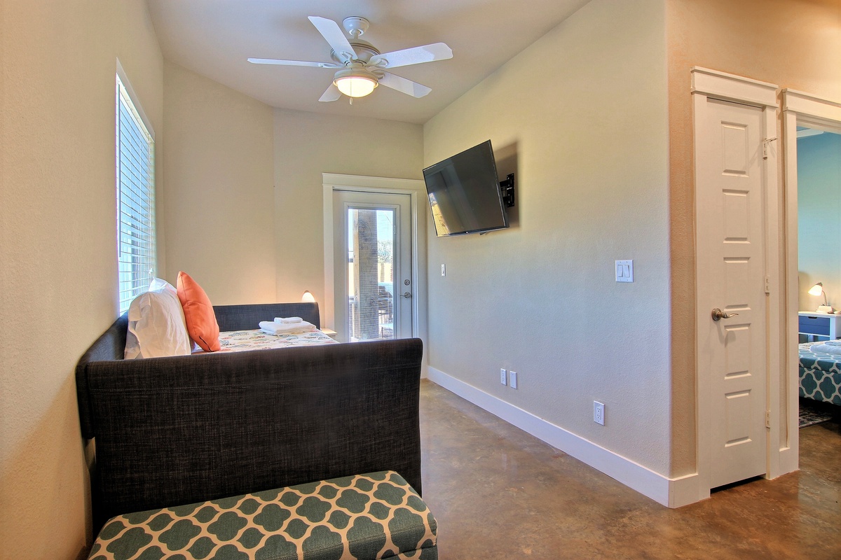 Relax in your modern living space with comfortable seating, entertainment, and thoughtful touches like the ceiling fan for perfect temperature control.