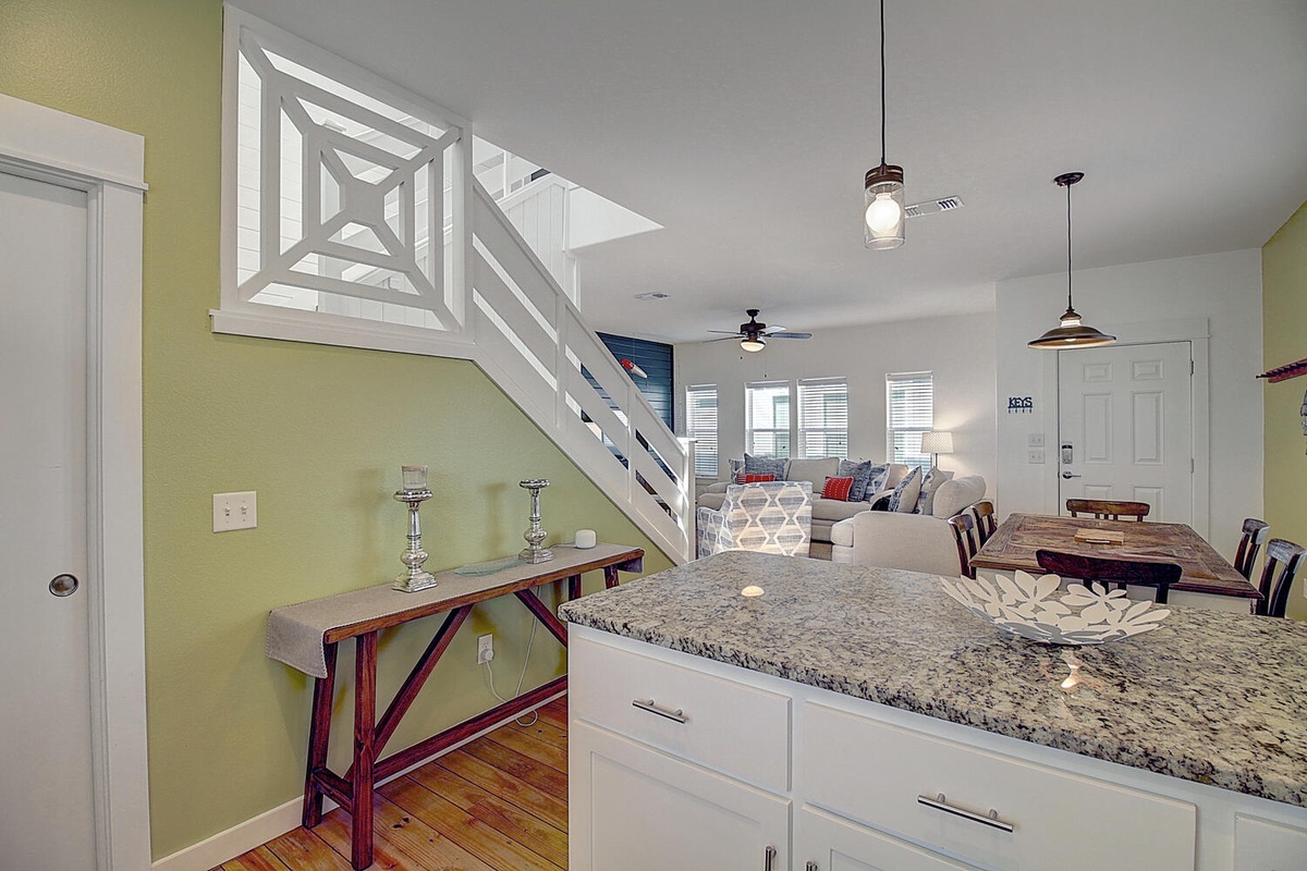 Your open-concept kitchen flows seamlessly into the living space, where granite countertops and stylish pendant lighting create the perfect spot for morning coffee or evening conversations.