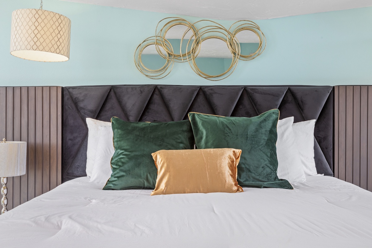 Slip into luxurious comfort with this elegantly styled bed featuring plush velvet pillows and designer touches.