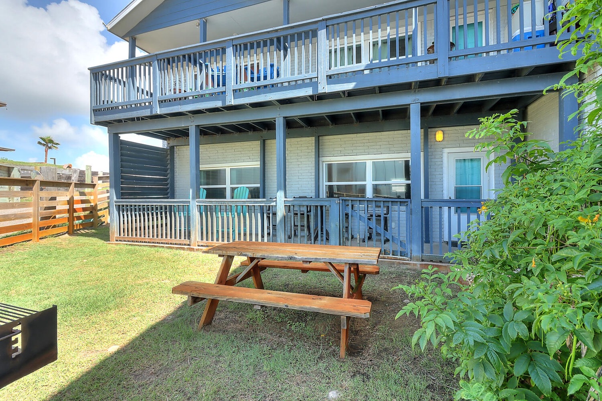 Relax on your private deck or enjoy outdoor dining at the picnic table in your spacious yard, surrounded by lush greenery.