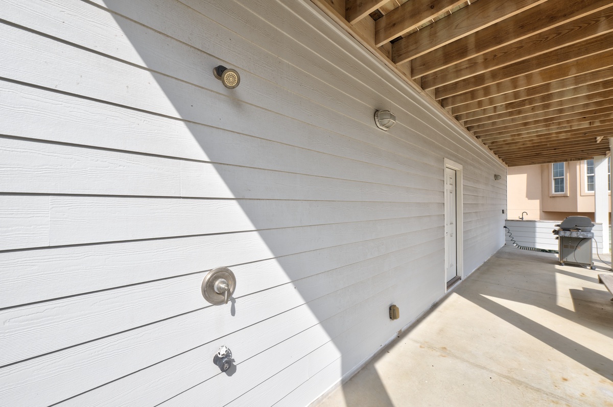 Your private outdoor shower awaits under the timber pergola, perfect for rinsing off after beach days or poolside relaxation.