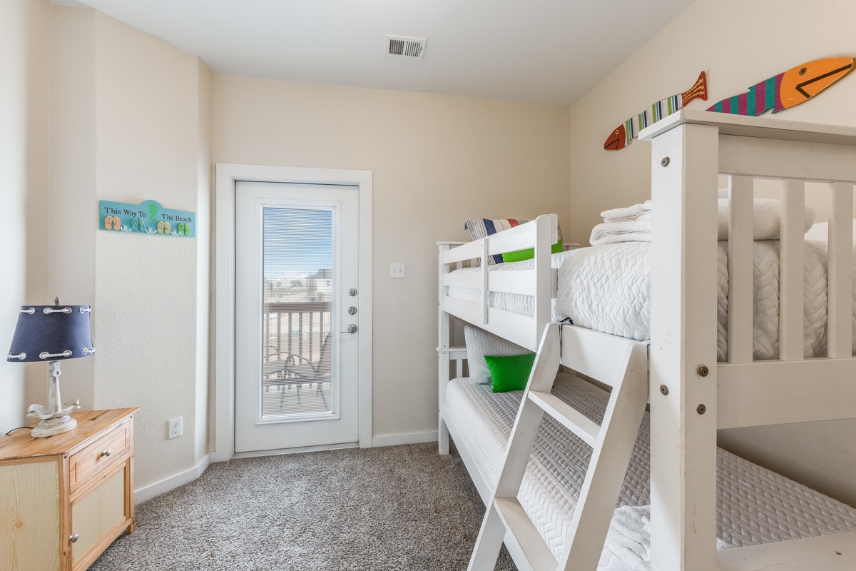 Rest easy in your cozy bunk room with beach-themed touches and private balcony access for those ocean breezes.