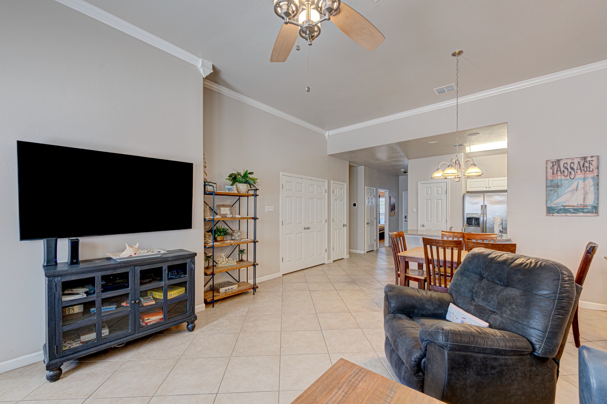Unwind in your spacious living area with comfy seating, large TV, and open flow to the kitchen—perfect for relaxing after beach days.