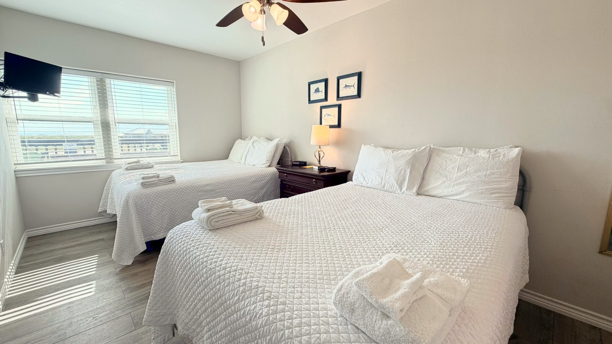 Settle in for a restful night in this cozy bedroom, complete with crisp white linens and a comfortable space to relax and unwind.