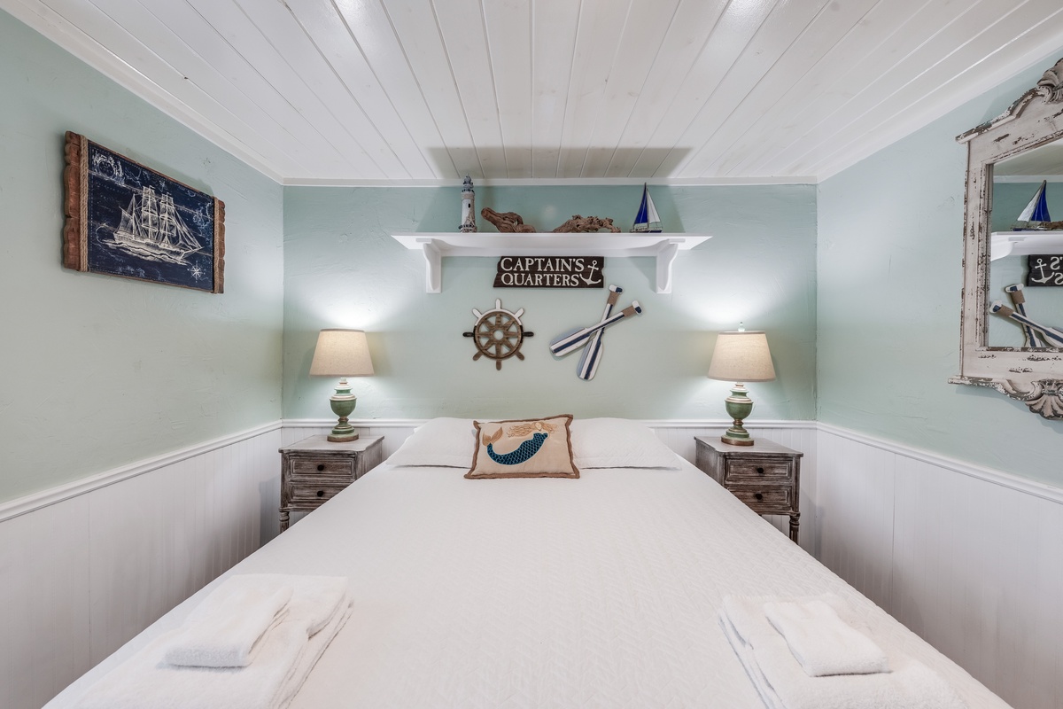Drift into peaceful sleep in this charming Captain's Quarters bedroom, where nautical details and soft coastal colors create your perfect seaside retreat.
