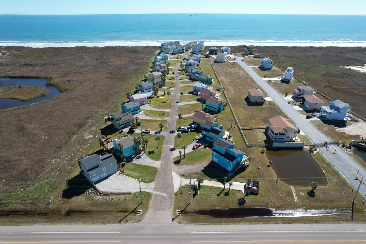 Coastal community with vacation homes positioned between the ocean and scenic waterways, offering direct beach access.