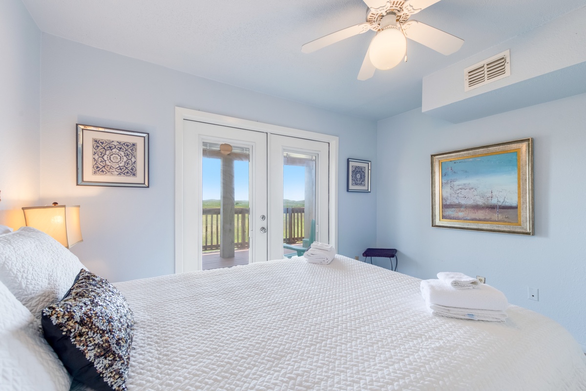 Wake to coastal views from your serene bedroom, where soft blues and gentle light create the perfect retreat for restful nights.