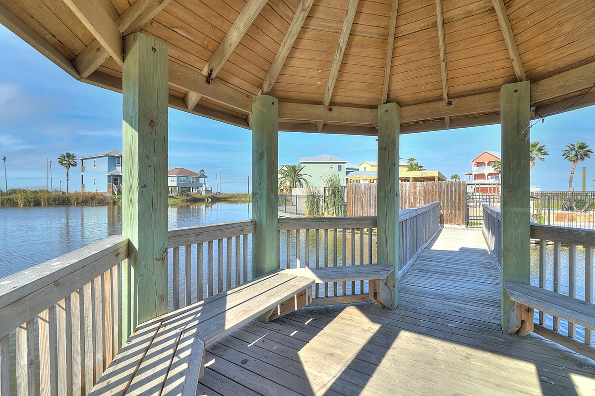 Waterfront gazebo offers peaceful moments overlooking the lagoon with comfortable seating and stunning water views.