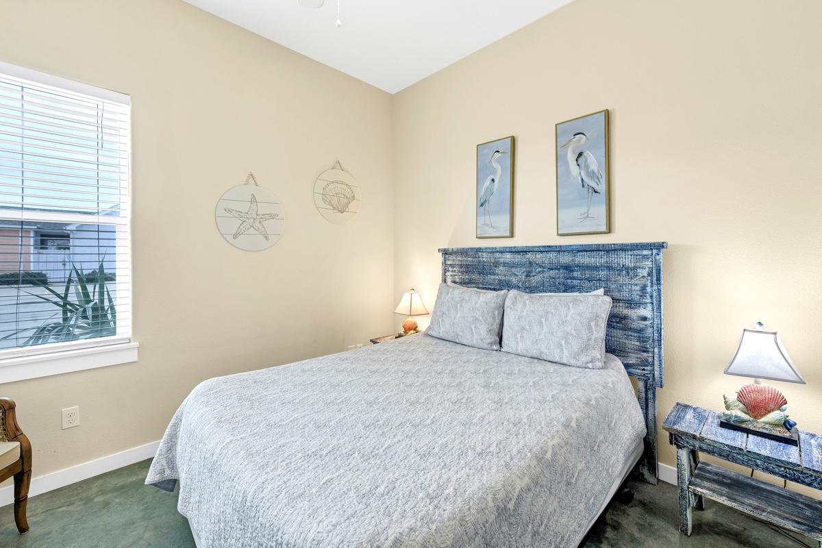 Rest peacefully in your coastal bedroom with ocean-inspired decor and serene blue tones creating the perfect seaside retreat atmosphere.