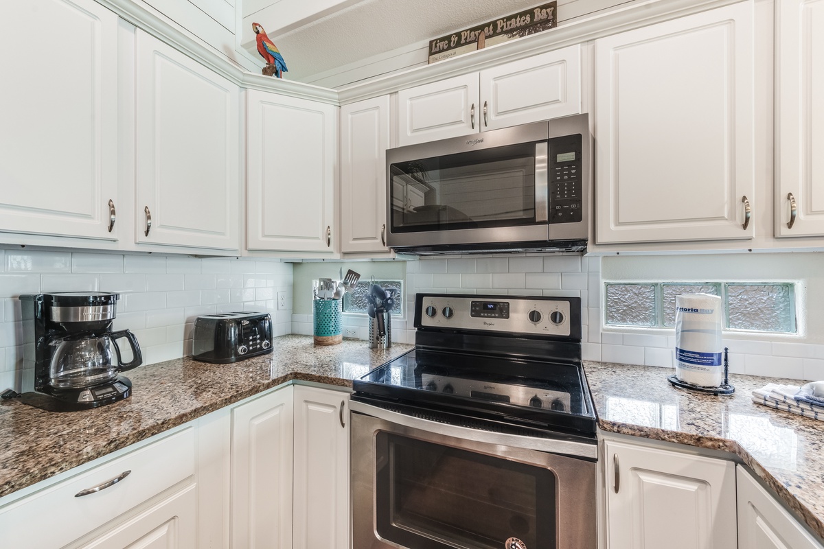 Your fully equipped kitchen welcomes you with granite counters, stainless appliances, and cheerful coastal touches for memorable meal prep.