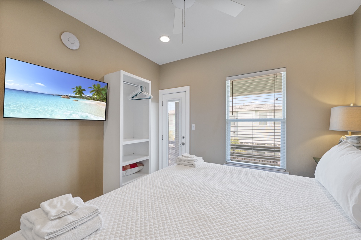 Unwind in your serene bedroom retreat with plush bedding, vaulted ceilings, and soft natural light streaming through the windows. Fresh towels and thoughtful touches await your arrival.