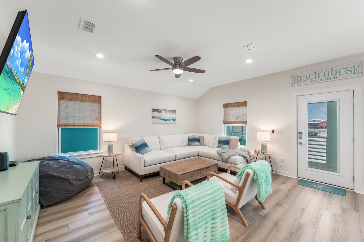 Sink into plush seating while cool coastal breezes flow through your bright, airy living space with modern beach-themed touches.