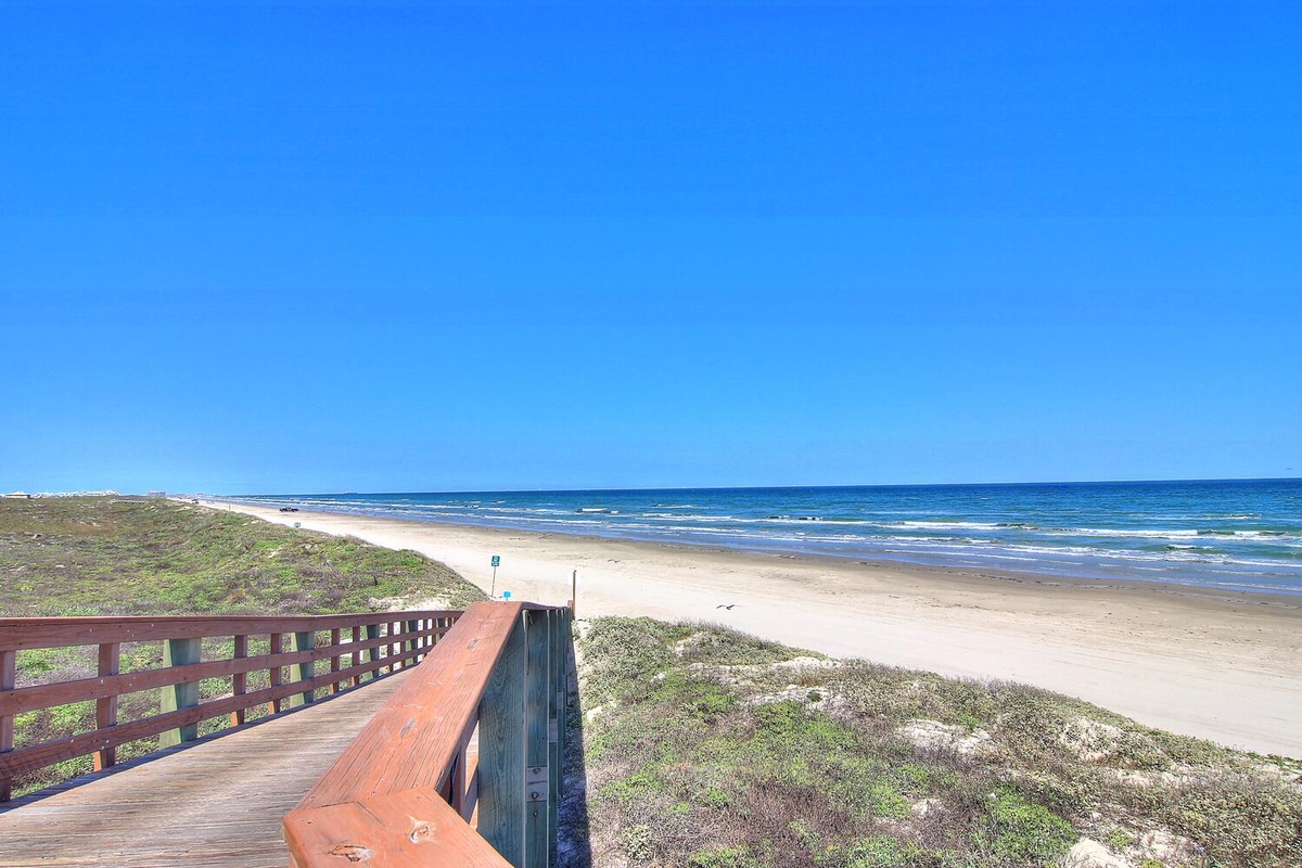 Pristine coastline with sandy beaches and rolling waves, just steps from the property.