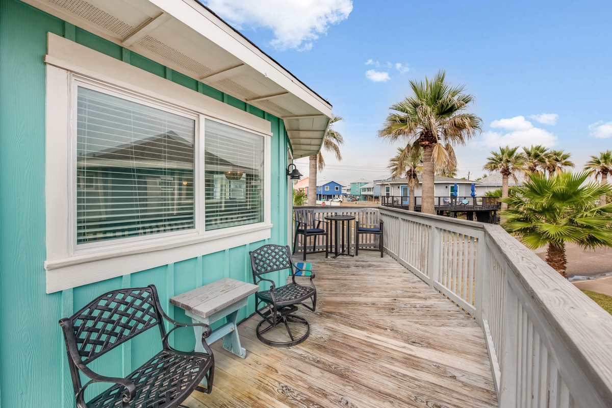 Soak up sunshine on your private deck overlooking colorful beach homes and swaying palms.