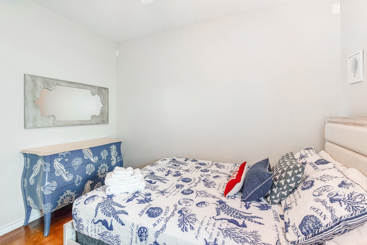 Drift off to sleep surrounded by charming coastal-themed linens and nautical touches in your peaceful bedroom retreat.