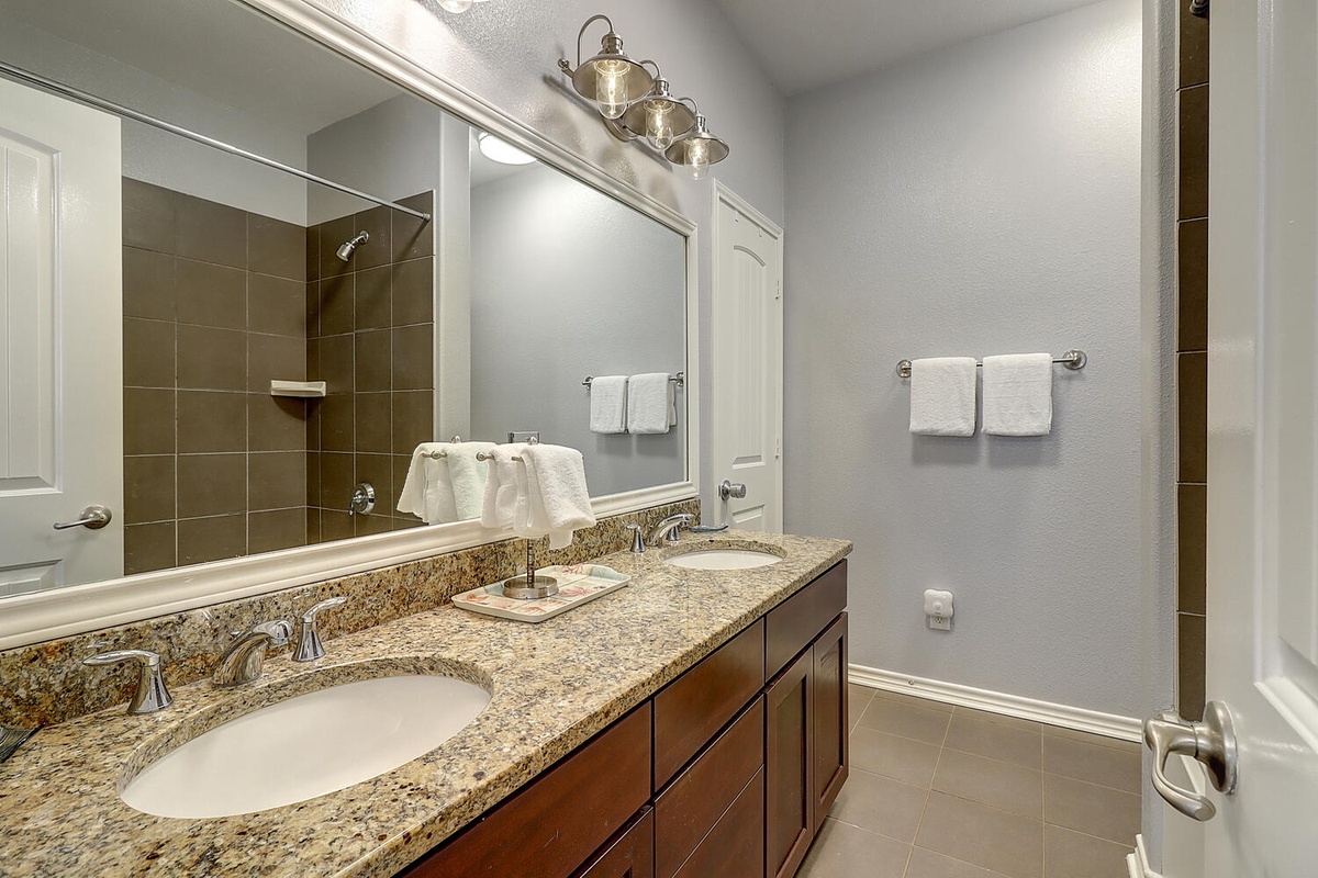 Step into your beautifully appointed bathroom with granite countertops, dual sinks, and a relaxing walk-in shower for your daily refresh.